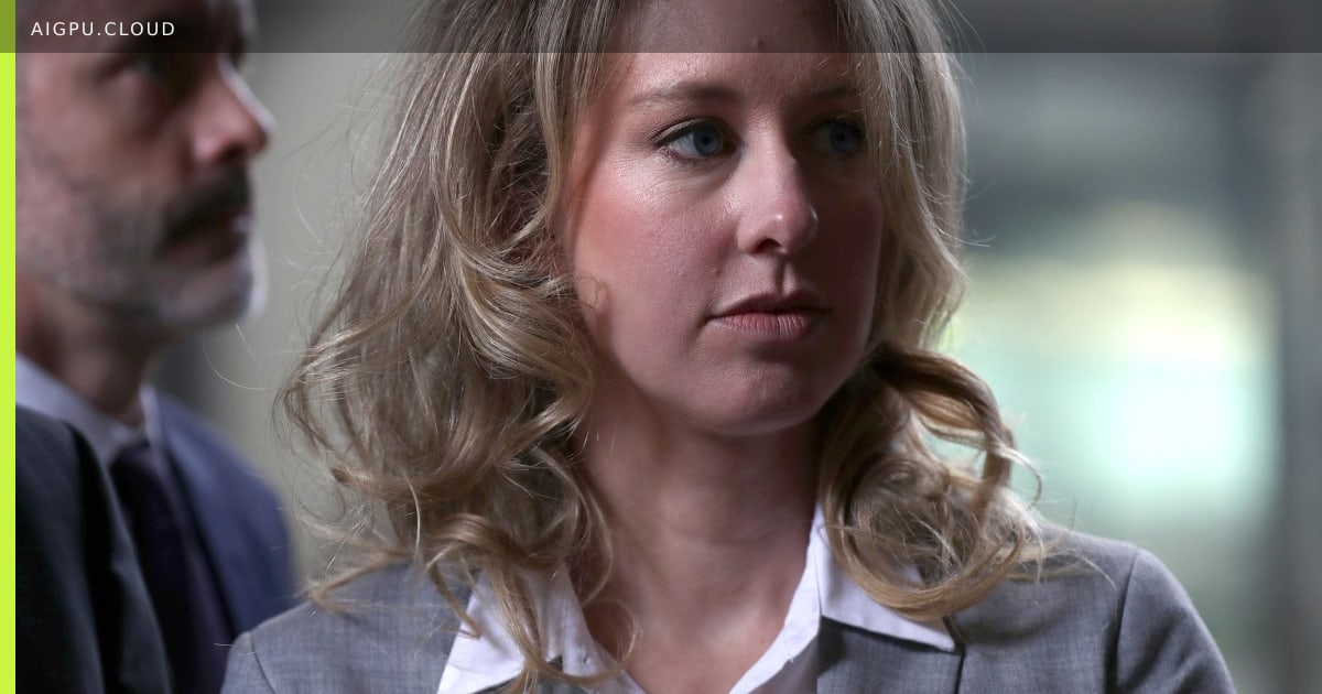 Screenshot of the Elizabeth Holmes desk simulator showing a virtual MacBook and iPhone